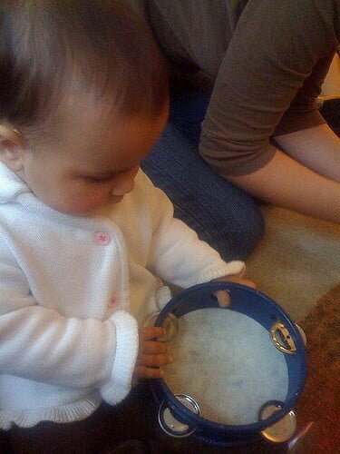 DIY toy tambourines Laila playing the tambourine in music class by Salim Virji https://www.flickr.com/photos/salim/4050817733/ via creative commons